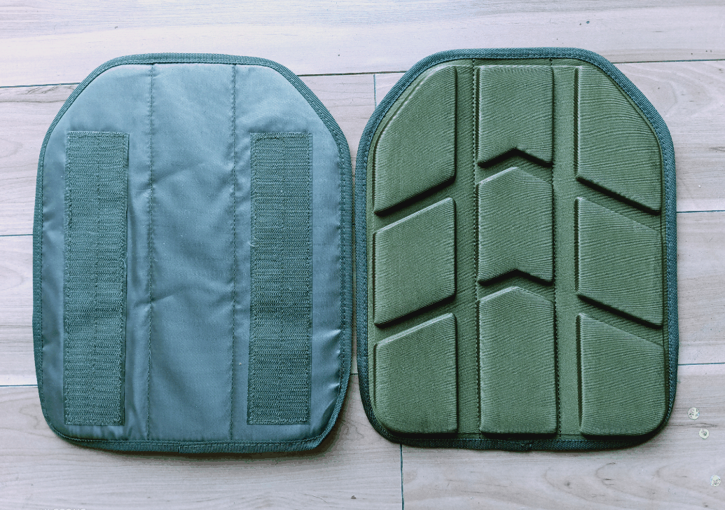 Ballistic nylon plate carrier, Harris tactical design, modular plates on wood background.