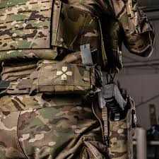 Tactical gear with quick release Molle system aid kit pouch.